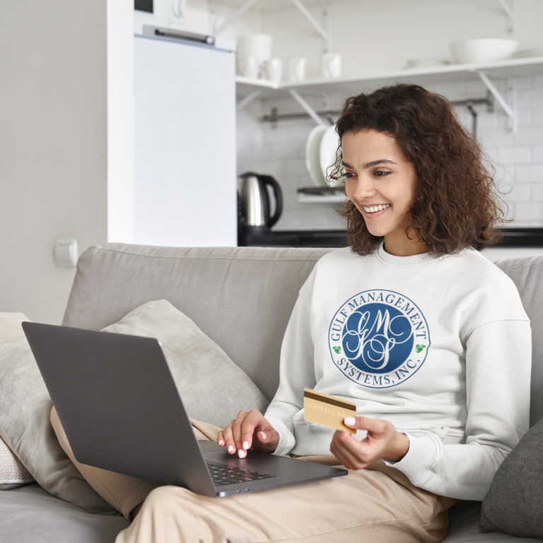 Image of a woman looking at her credit card fees on a computer