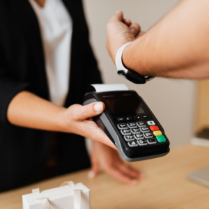 Image of mobile credit card processing using tap to pay featuring a smartwatch